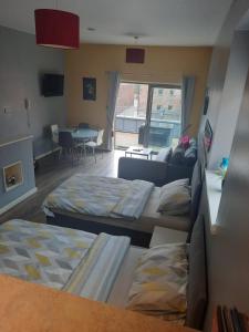 a living room with two beds and a couch at Campbell Square Apartment in Liverpool