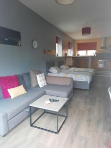 a living room with a couch and a table at Campbell Square Apartment in Liverpool