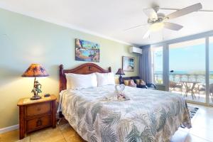 a bedroom with a bed and a window with a view at Islander on the Beach 250 in Kapaa