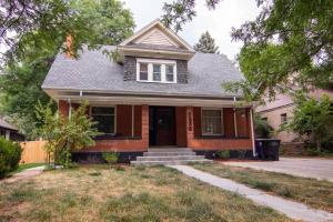 a red brick house with a gambrel roof at Perfect Urban Sanctuary for 8 w Hot Tub near City Park in Denver