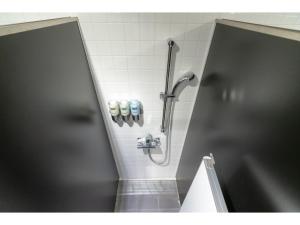 a bathroom with a shower in a stall at The Lodge Moiwa 834 - Vacation STAY 36148v in Niseko +13 photos