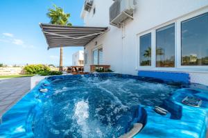 a swimming pool in the backyard of a house at Dene Hollow in Oroklini