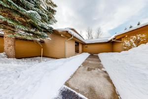 a house covered in snow with a driveway at Golf Creek12 in Teton Village