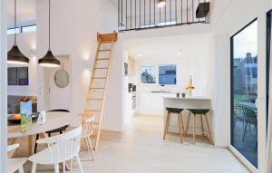 a kitchen and a dining room with a ladder in a house at Nice Home In Lembruchdümmer See in Lembruch