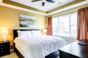 a bedroom with a white bed and a window at Golf Retreat 832 in North Myrtle Beach +20 photos