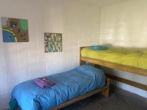 a room with two bunk beds with blue sheets at Departamentos Temporales con Wifi, Tv y Aire in Oliva