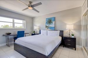 a bedroom with a bed and a ceiling fan at Ocean Reef at Deerfield #3 in Deerfield Beach