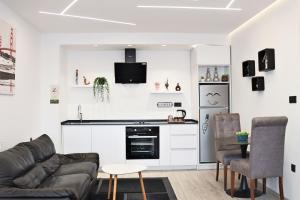 a living room with a couch and a kitchen at Matin Apartments in Pristina, Kosovo in Pristina