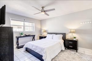 a bedroom with a bed and a ceiling fan at Deerfield Delight #2 in Deerfield Beach