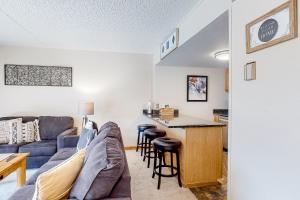 a living room with a couch and a table at Center Village Hideaway in Frisco