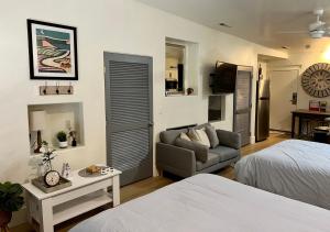 a bedroom with a bed and a couch and a table at St George Resort Condo in St. George