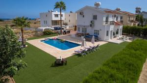 an aerial view of a house with a swimming pool at Dene Hollow Oroklini in Voroklini
