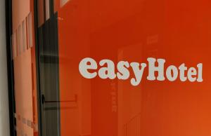 a sign for an easy hotel on the side of a building at easyHotel Madrid Centro Atocha in Madrid