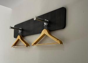 two wooden hangers hanging on a wall at easyHotel Madrid Centro Atocha in Madrid