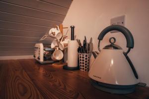 a kitchen counter with a tea kettle and other kitchen utensils at Wood Fired Hot Tub & Pergola with Glass Balcony. in Brecon