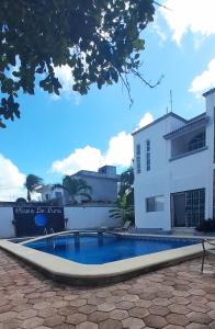 a swimming pool in front of a house at Claro de Luna in Playa del Carmen