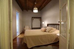 a bedroom with a bed with pillows on it at Casa Rural La Chiquitita in Alaejos