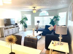 a living room with a blue couch and a table at LOVELY RENOVATED APARTMENT 3/2 CLOSE DISNEY in Kissimmee