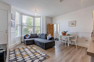 a living room with a couch and a table at Dizzy Lows in Swanage