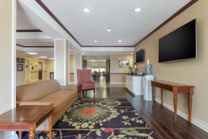 a living room with a couch and a flat screen tv at Best Western Lawrenceburg Inn in Lawrenceburg