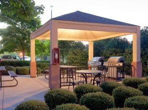 a gazebo with a picnic table and two stoves at Sonesta Simply Suites Chicago Libertyville in Libertyville