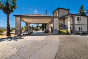 a house with a garage with cars parked in it at SureStay Hotel by Best Western Ukiah in Ukiah