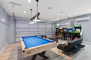 a pool table in a room with arcade games at Villa Paradise Miami, Luxury Gem with Heated Pool, Game Room, Fire Pit, 3 Bed 2 Bath in Miami