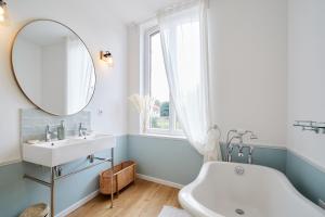a bathroom with a sink and a mirror at VILLA SANDERLING au cœur de Saint Valery Haut standing 5 étoiles in Saint-Valéry-sur-Somme