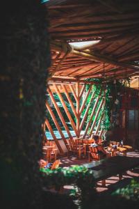 a person sitting at a table in a wooden building at Lush Atitl&aacute;n in San Marcos La Laguna