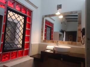 a bathroom with a sink and a mirror at Hotel Sonno Plaza Allende in Mexico City