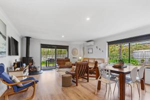 a living room with a table and chairs at The Summer House ~ 2 blocks to Beach in Apollo Bay