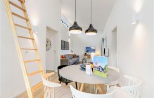 a room with a table and chairs and a ladder at Beach Front Home In Lembruch-dmmer See With Wifi in Lembruch