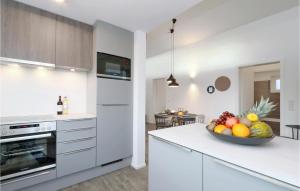 a kitchen with a bowl of fruit on a counter at Lovely Home In Lembruchdümmer See in Lembruch