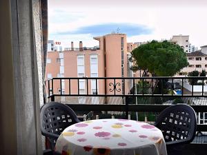a table on a balcony with a view of a city at Inviting apartment in Torremolinos with shared pool in Torremolinos