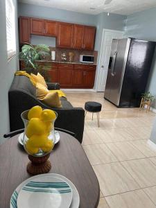 a living room with a table and a refrigerator at The Citrus Guesthouse in Tampa in Tampa