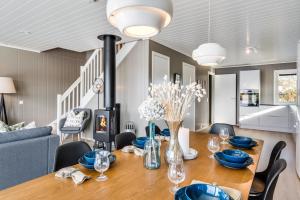 a dining room with a wooden table with blue dishes on it at Rorsundet Brygge in Vega +46 photos
