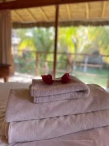 a pile of towels with roses on top of a bed at La Casa de Pitty in Máncora