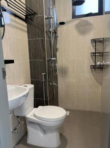 a bathroom with a toilet and a sink at Attractive 3 Bedroom Condo with Pool-D Raudhah Homestay in Kajang