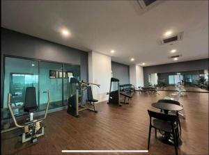 a room with a gym with chairs and a table at Attractive 3 Bedroom Condo with Pool-D Raudhah Homestay in Kajang