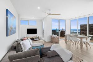 a living room with a couch and a table at Point Grey Apartment 2 in Lorne