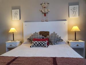 a bedroom with a large bed with two lamps at Marfil in Posadas