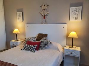 a bedroom with a bed with two lamps and a teddy bear on top at Marfil in Posadas