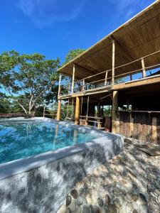 a swimming pool in front of a building at Casa Xadani in Cerro Largo