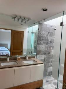 baño con 2 lavabos y ducha de cristal en Casa Padvon- Private Residence with espectacular Roof Garden - 3BR 3BTH, en Ciudad de México