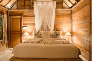 Postel nebo postele na pokoji v ubytování Nauna Villa Ubud