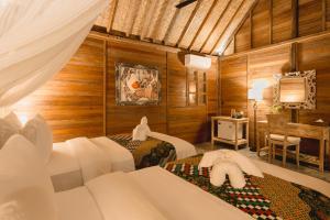 Postel nebo postele na pokoji v ubytování Nauna Villa Ubud
