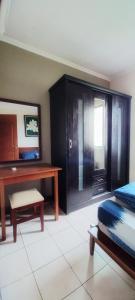 a bedroom with a desk and a bed and a table at Mediterania palace residences kemayoran in Jakarta