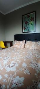 Una cama con una colcha con flores. en Mediterania palace residences kemayoran, en Yakarta