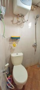 a bathroom with a white toilet and a sink at Mediterania palace residences kemayoran in Jakarta