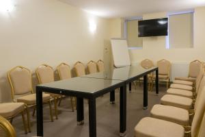a conference room with a black table and chairs at Hotel Crisalpin in Poiana Brasov
